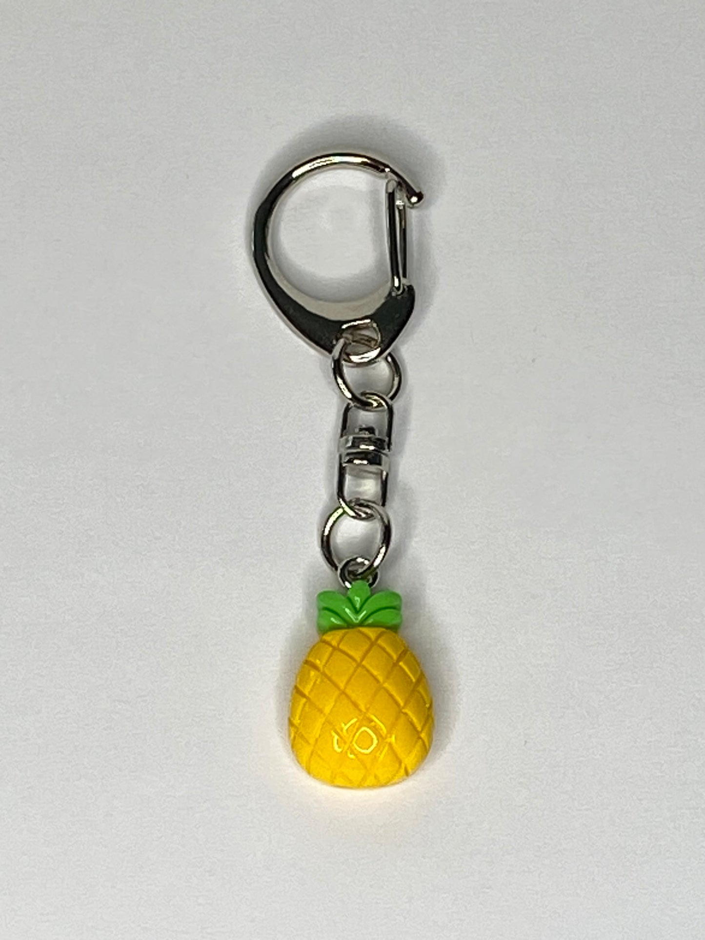 Pineapple-shaped keychain on a white background