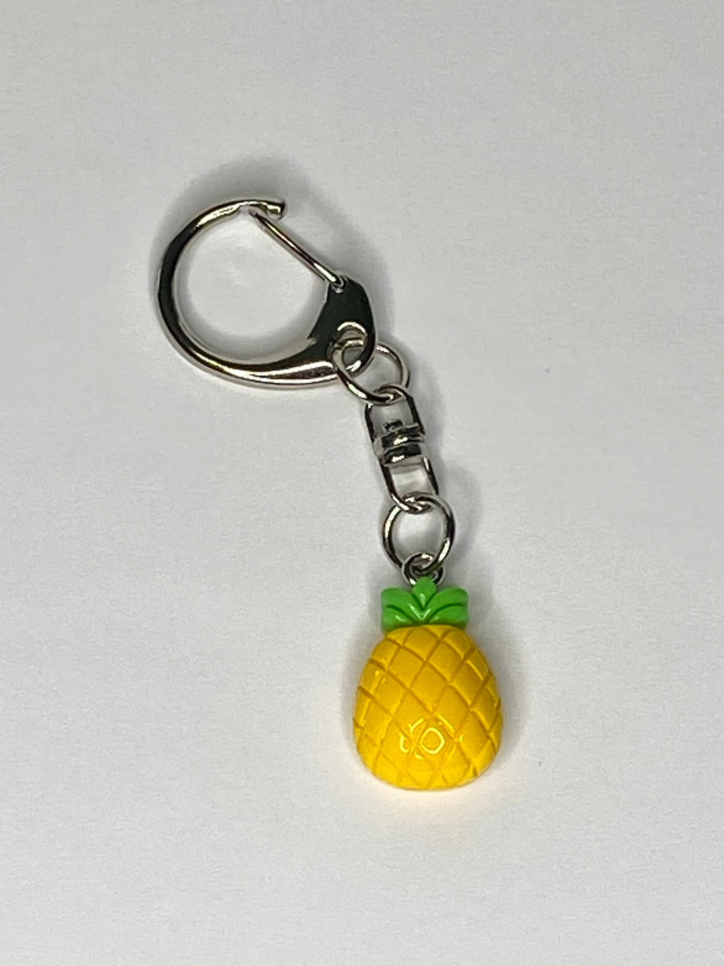 Pineapple-shaped keychain on a white background