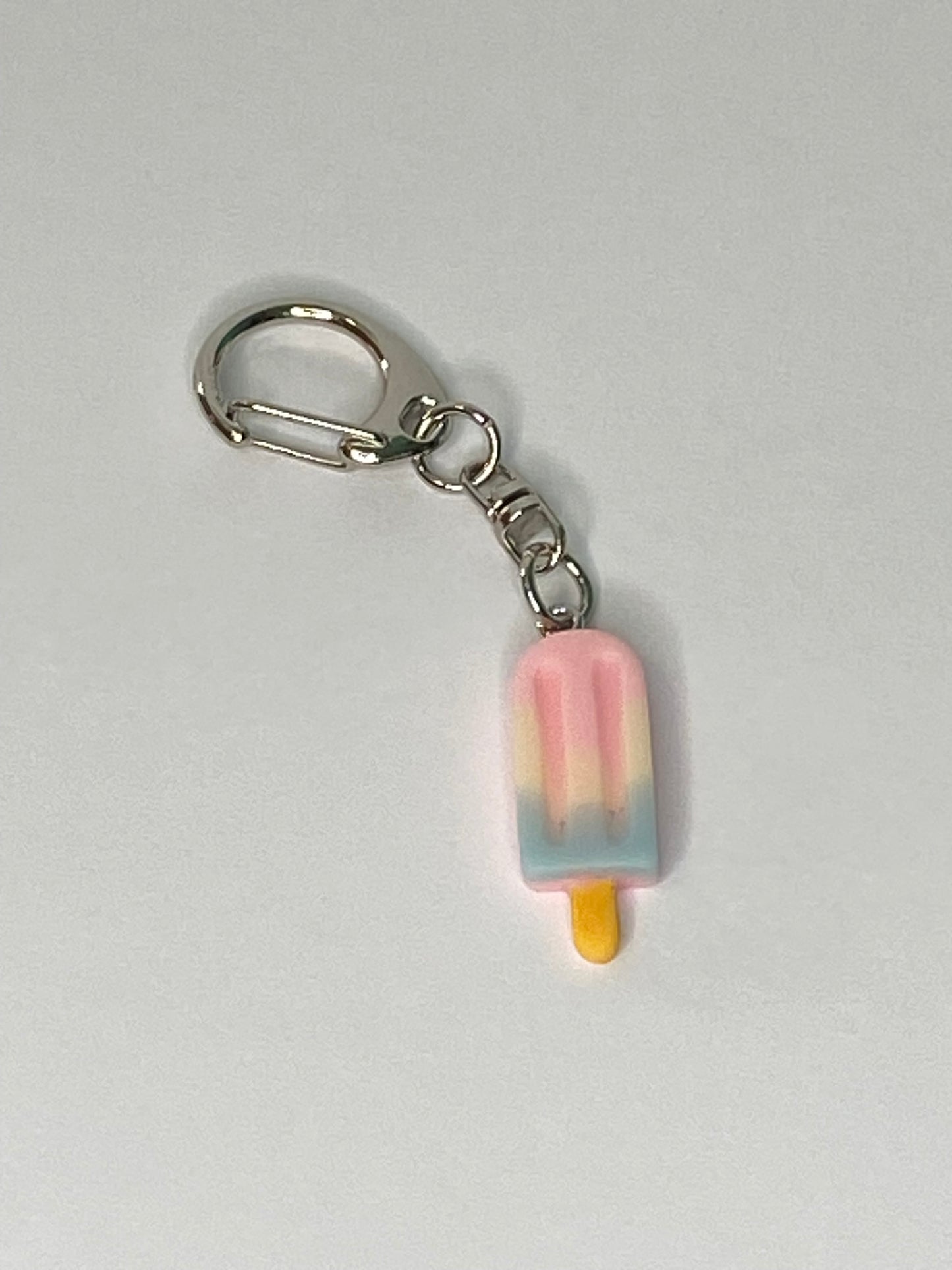 Popsicle-shaped keychain on a light gray background