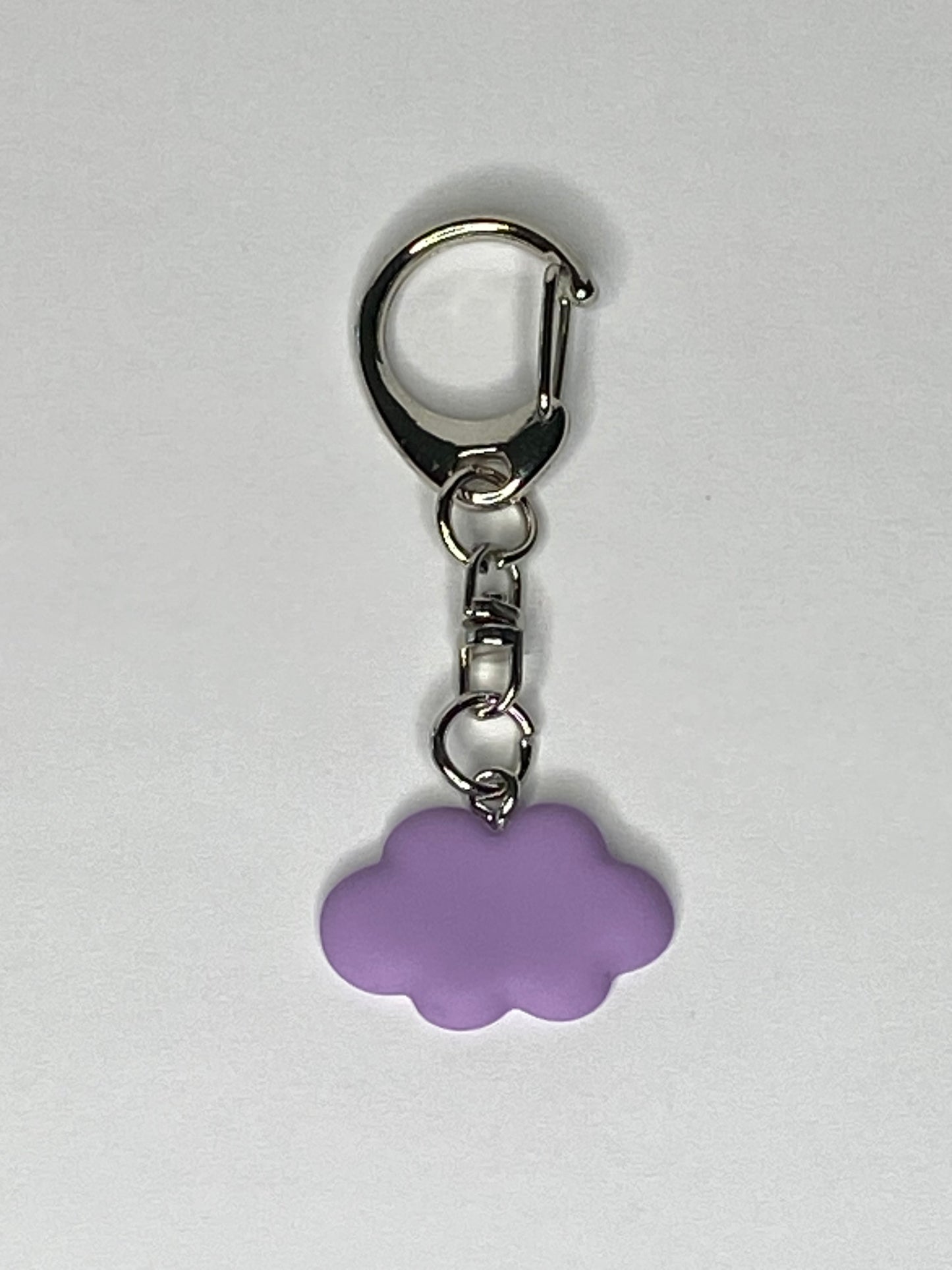 Keychain with a purple cloud-shaped charm on a light gray background