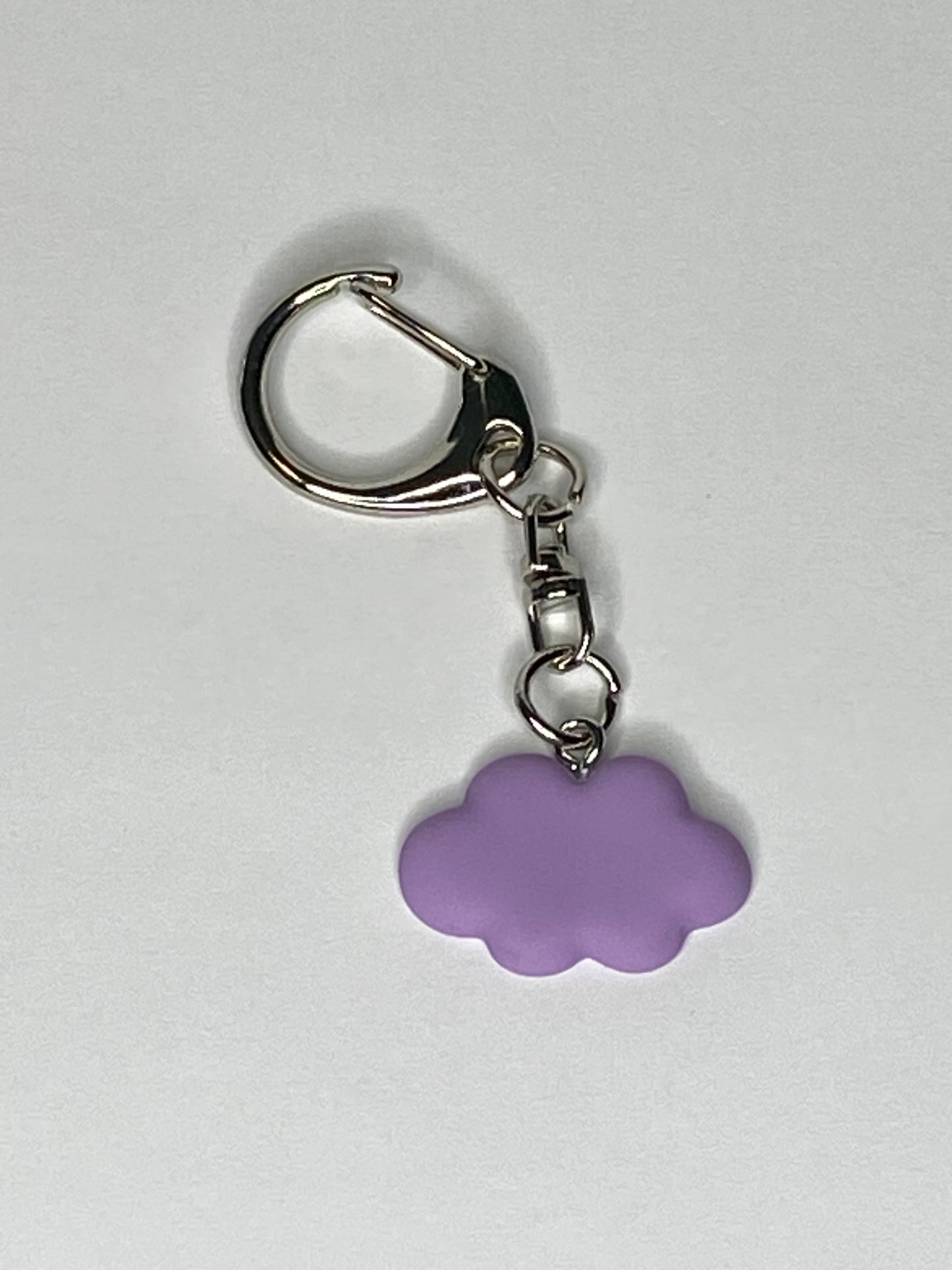 Keychain with a purple cloud-shaped charm on a light gray background