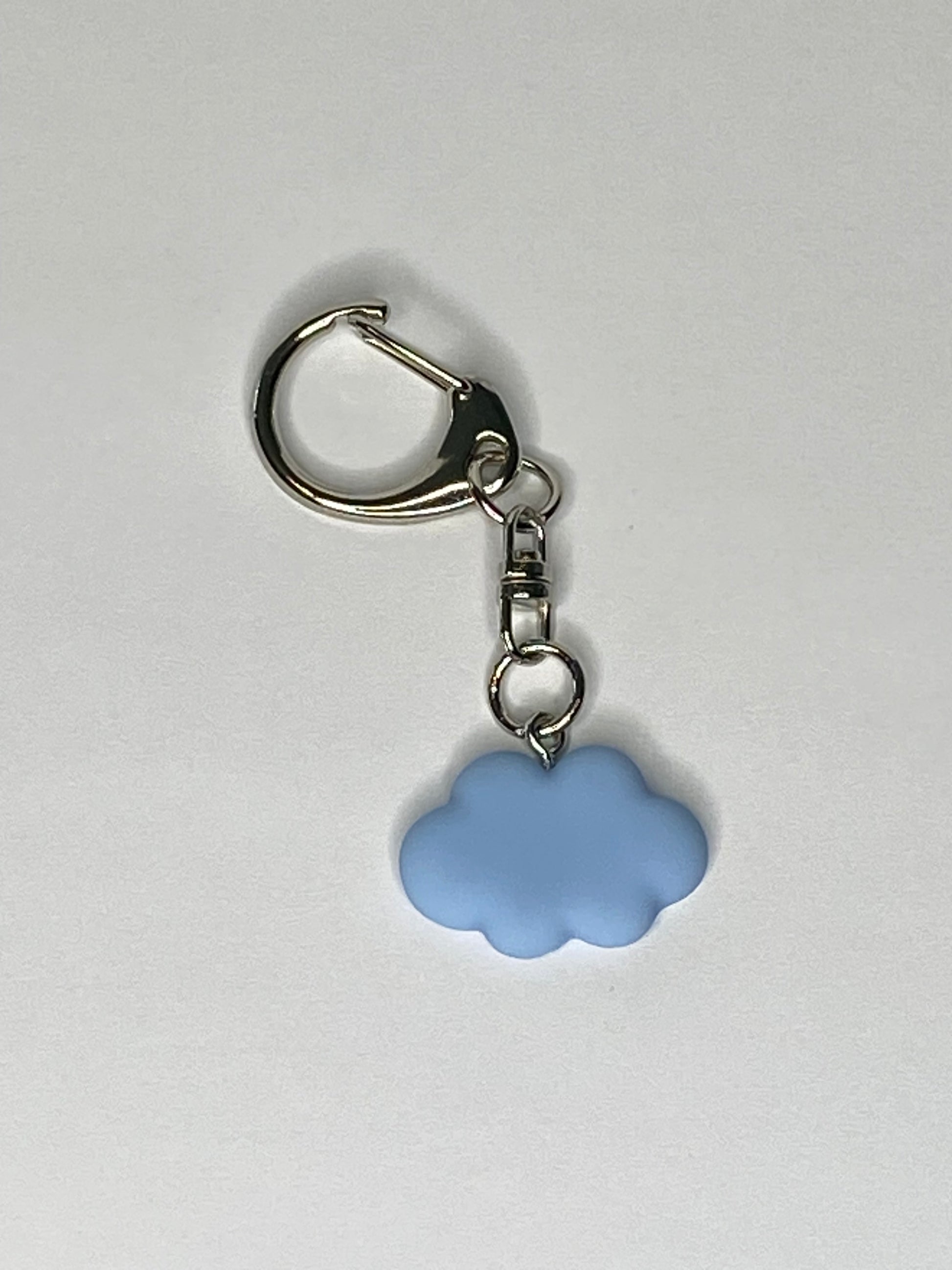 Keychain with a blue cloud-shaped charm on a light gray background