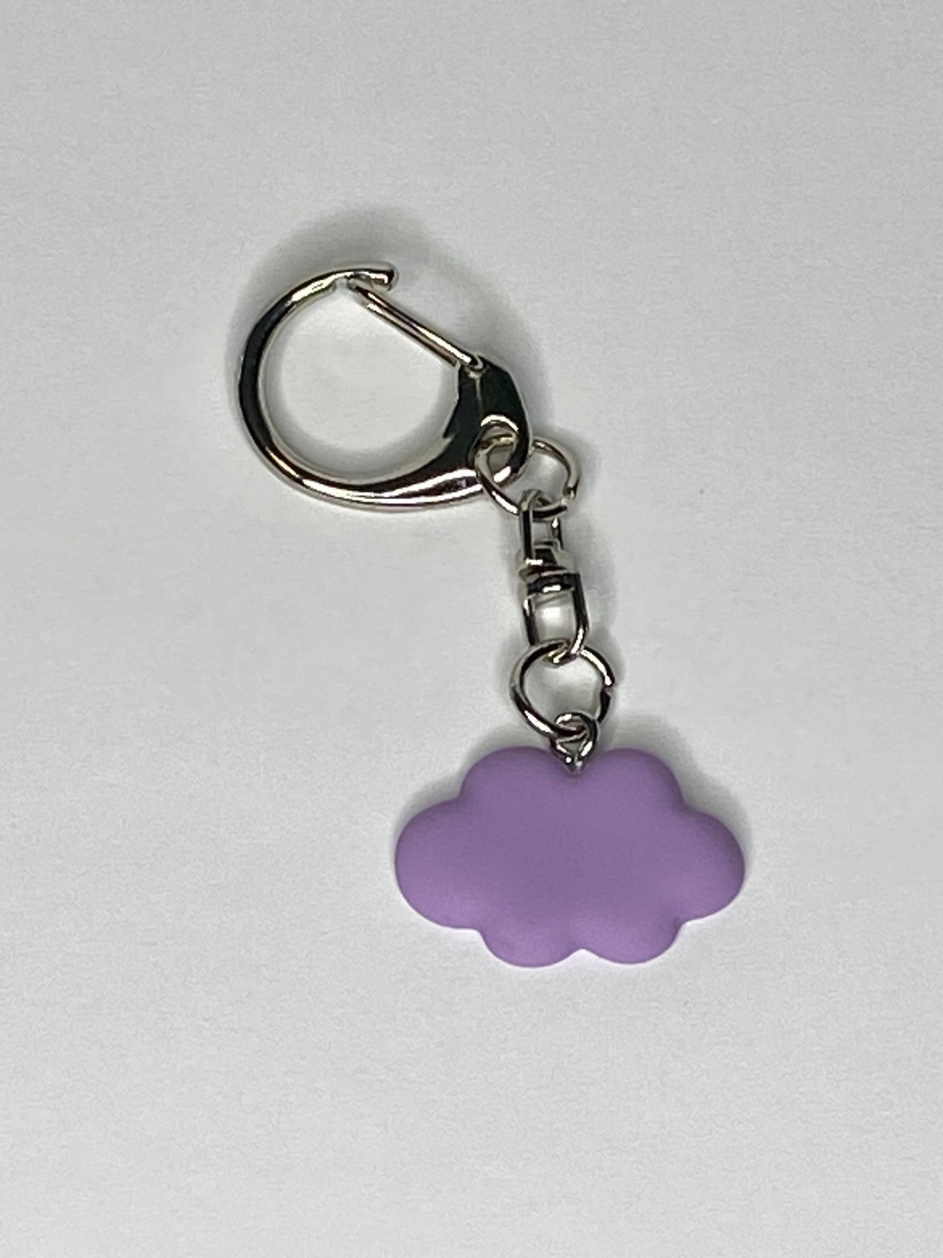 Keychain with a purple cloud-shaped charm on a light gray background