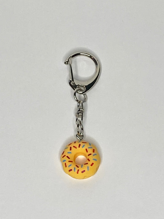 Keychain with a yellow donut charm on a light gray background